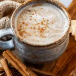 Aromatic Masala tea in cup, spices and brown sugar on grey table, flat lay
