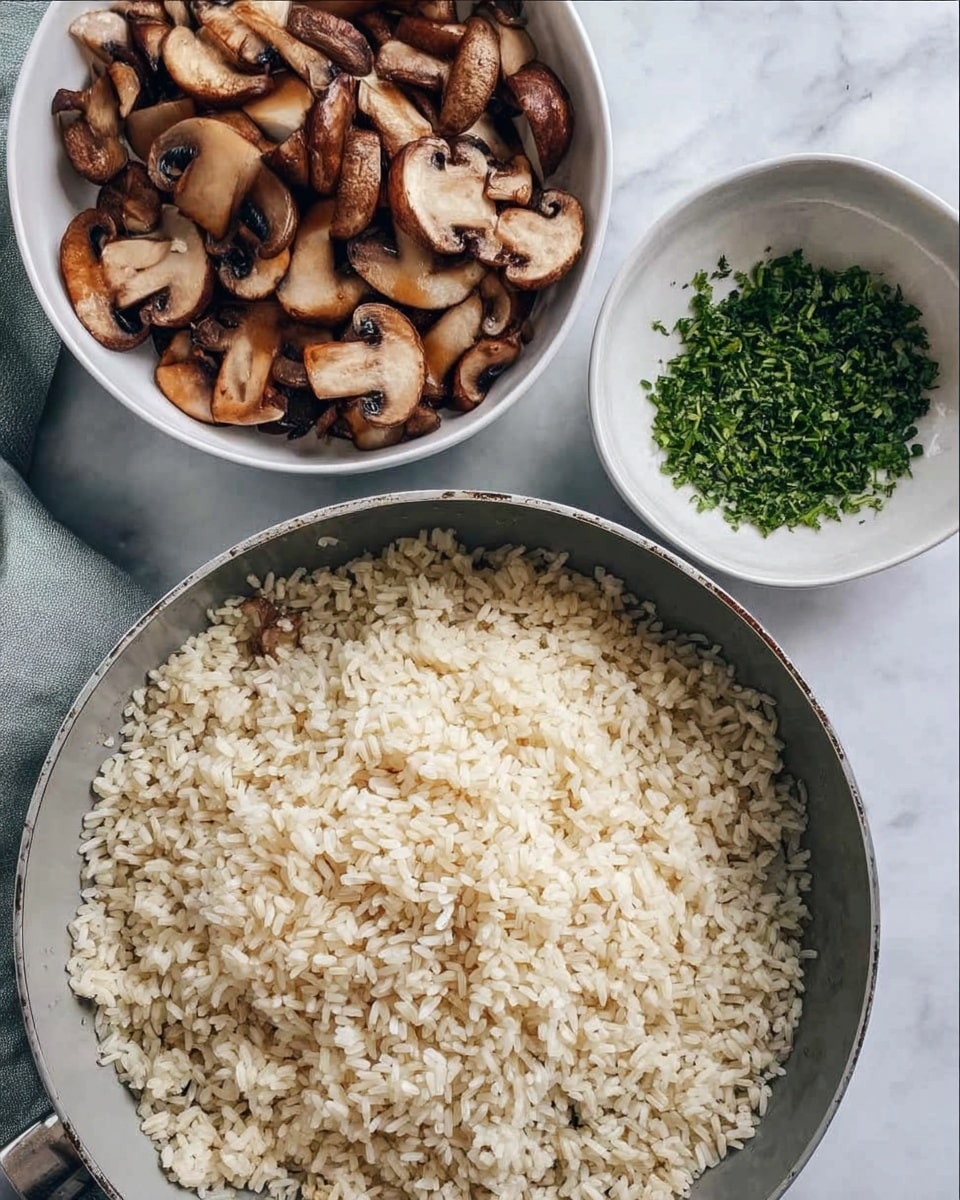 The image shows three bowls on a white marbled surface. The largest bowl at the bottom is a pan filled with unevenly toasted rice grains, pale beige in color, spread across the bottom. To the upper left, there is a white bowl filled with sliced, cooked mushrooms that are brown with darker edges. To the upper right, there is a small white bowl with chopped green herbs. The overall scene looks like preparation for a dish, with a soft, natural light highlighting the textures. photo taken with an iphone --ar 4:5 --v 7