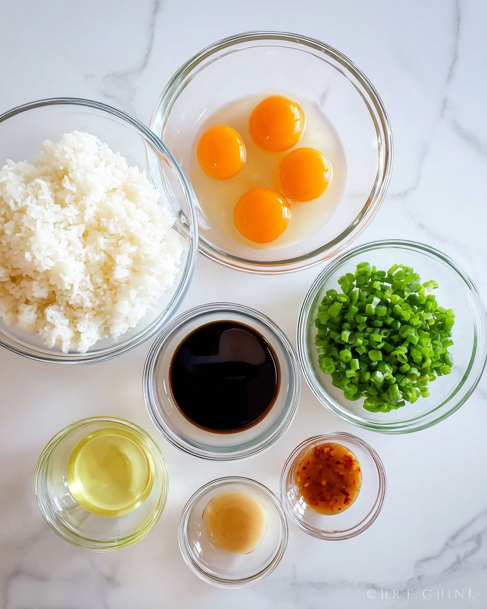The image shows six clear glass bowls on a white marbled surface. The largest bowl in the top left holds a layer of white cooked rice with a fluffy texture. Below it, a slightly smaller bowl contains four raw eggs with bright orange yolks surrounded by clear egg whites. To the right of the rice, there are two small bowls; the upper one holds dark brown soy sauce with a smooth, shiny surface, and below it is a bowl with light yellow oil. Next to these, in the top right corner, is a bowl filled with chopped green onions, showing small, vibrant green rings. Below the green onions is the smallest bowl, holding a small amount of light brown sauce with a hint of red. Photo taken with an iphone --ar 4:5 --v 7