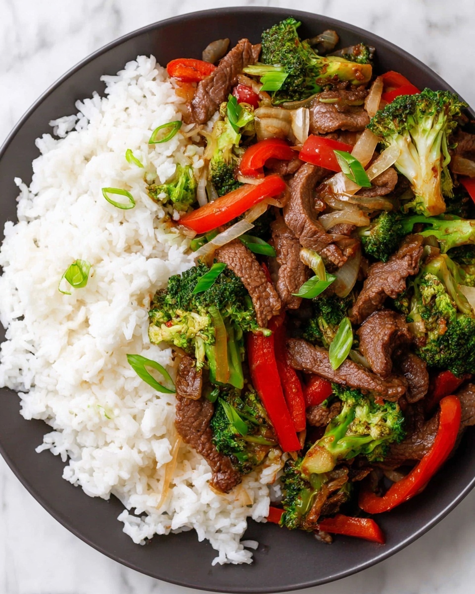 A white plate is filled halfway with white rice that looks fluffy and soft. On the other half of the plate, there is a stir-fry mix layered on top of the rice and plate. The stir-fry has several layers: the bottom layer is cooked beef slices that are brown with a slight shine, above and mixed with the beef are bright green broccoli pieces with small florets, thin strips of red bell pepper adding a vivid red color, and translucent sautéed onion slices that have a soft golden-brown look. Thin green onion slices are scattered on top for a fresh green contrast. The plate sits on a white marbled surface. Photo taken with an iphone --ar 4:5 --v 7