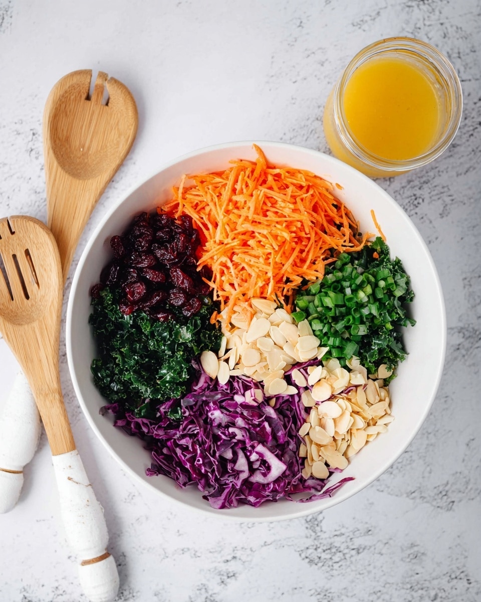 A white bowl is filled with six separate layers arranged in a circle: shredded orange carrots on the left top, dark red dried cranberries next to it, chopped green onions on the top right, finely chopped dark green kale below the onions, slivered light beige almonds on the bottom right, and shredded purple cabbage on the bottom left. Beside the bowl, there is a small glass jar with a yellow-orange dressing on a white marbled surface, along with wooden salad utensils wrapped in white handles placed nearby. Photo taken with an iphone --ar 4:5 --v 7