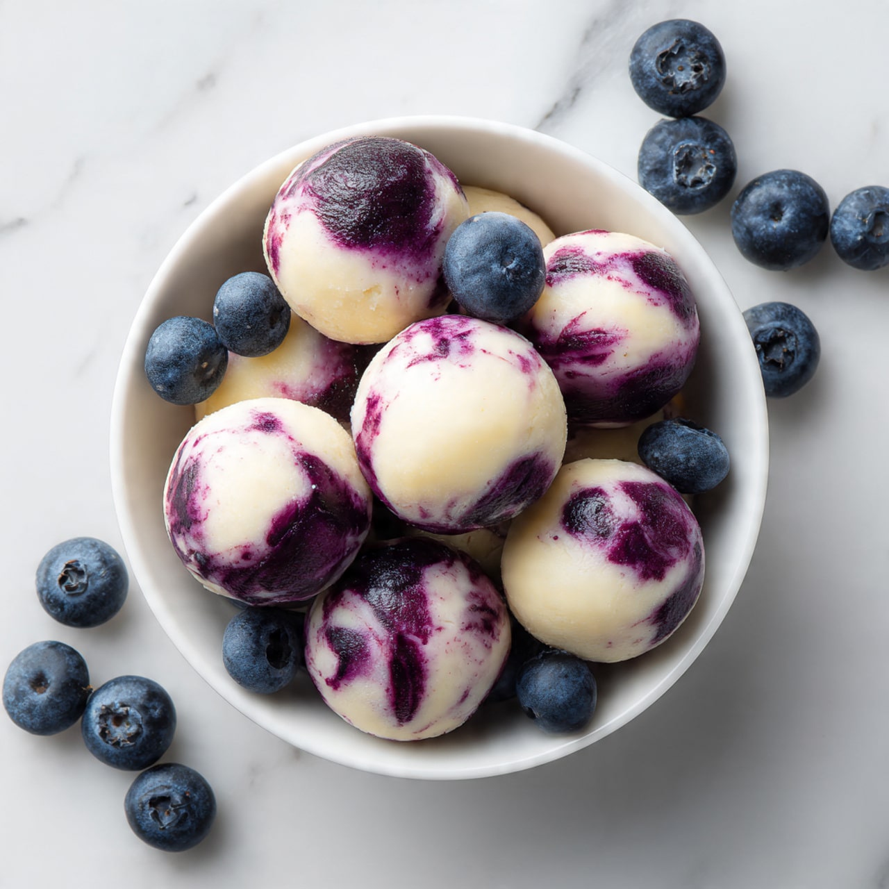 The image shows three white ramekins filled with two layers: a bottom layer of creamy white ice cream and a top layer of purple blueberry sauce drizzled unevenly over the ice cream, creating soft purple streaks. Fresh whole blueberries rest on top and around the edge of the ramekins. A woman’s hand is holding a silver fork, lifting a scoop of the ice cream with blueberry sauce swirled on it. The background and surface are white with a marble texture, creating a clean and bright look. Photo taken with an iphone --ar 4:5 --v 7