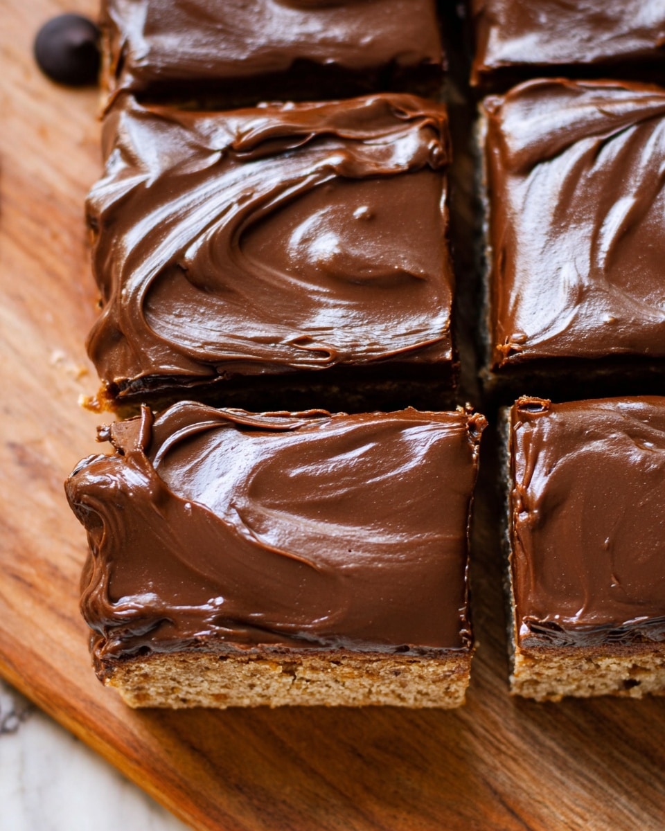 A close-up view of a square dessert cut into six large pieces, each topped with a thick, smooth, and shiny layer of rich dark chocolate frosting with visible swirls. The cake layer underneath is light brown with a slightly grainy texture and is visible around the edges and between the chocolate-covered pieces. One dark chocolate chip is partially visible on the top left corner of the cake. The dessert sits on a wooden surface with a white marbled texture added in post-processing. photo taken with an iphone --ar 4:5 --v 7