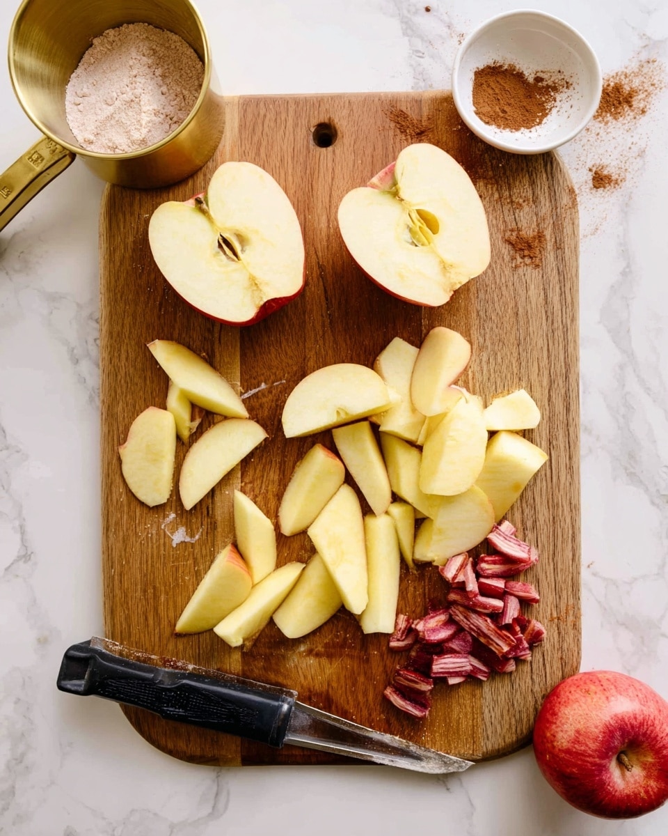 A wooden cutting board with two large peeled apple halves at the top left, along with several yellowish apple slices spread across the middle and bottom of the board. To the right side on the board is a small pile of red apple peels and cores. A black peeler lies on the bottom left corner of the board. The board is set on a white marbled surface, with a brass measuring cup filled with flour at the top left, a small white bowl with brown cinnamon powder at the top right, and a whole red apple near the right edge. photo taken with an iphone --ar 4:5 --v 7