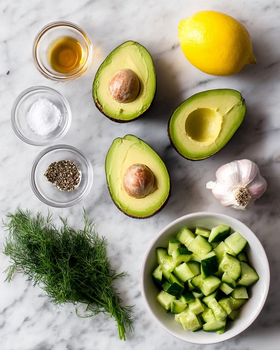 The image shows four avocado halves with green rough skin and soft yellow-green inside, two with large brown seeds and two without. Near the avocados, there is a bright yellow lemon with smooth skin. There are two whole garlic bulbs with off-white skin. Three small glass bowls contain different things: one with light brown liquid, one with white salt and black pepper mixed, and one with fresh, dark green dill leaves. A white bowl holds small green cucumber cubes with dark green skin. All items are placed on a white marbled surface. photo taken with an iphone --ar 4:5 --v 7