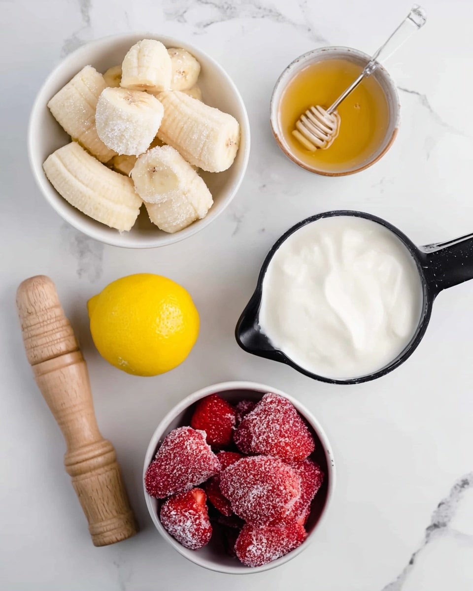 The image shows a white bowl filled with frozen banana pieces on the top left, their pale yellow color covered with frost. Below it, there is a small white bowl with honey, its golden, smooth surface reflecting light. To the right, there is a black measuring cup filled with thick white yogurt. On the bottom right, a white bowl holds frost-covered strawberries, bright red with icy texture visible on their surface. At the bottom left, a whole yellow lemon sits next to a wooden lemon squeezer on a white marbled surface. photo taken with an iphone --ar 4:5 --v 7