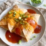 Air Fryer Chicken Chimichangas with Enchilada Sauce and Toppings Recipe