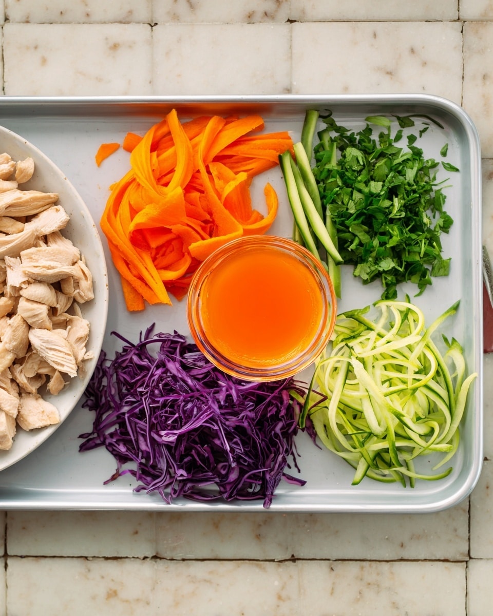 A white tray holds six sections: the center has a small clear bowl filled with an orange liquid and some carrot strips inside. Around the bowl, from left to right, there are thin green bean slices, bright orange carrot sticks, finely chopped green herbs, a heap of shredded purple cabbage, and thin green cucumber strips. To the left of the tray, part of a white plate with cooked sliced chicken pieces is visible. All items are placed on a white marbled surface. Photo taken with an iphone --ar 4:5 --v 7