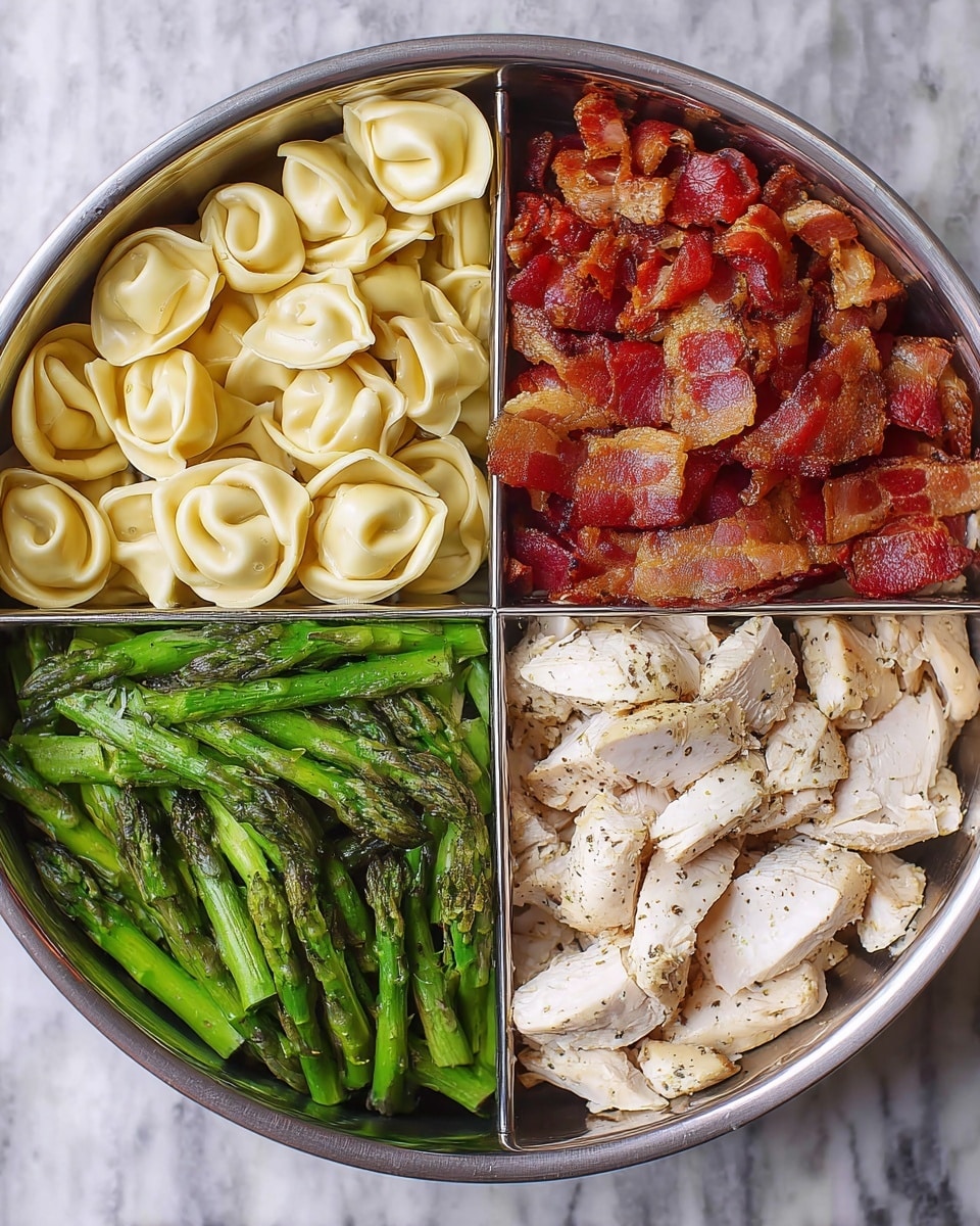 A round metal pan with four clear sections of food inside, each showing a different layer. The top left layer has light yellow tortellini with a smooth, slightly glossy texture, arranged in a neat cluster. The top right layer holds crispy bacon pieces with a shiny red and brown crispy look. The bottom right layer contains white cooked chicken strips with light brown seasoning spots, showing a tender texture. The bottom left layer features bright green asparagus spears with a fresh, slightly shiny look. The pan is placed on a white marbled surface. Photo taken with an iphone --ar 4:5 --v 7