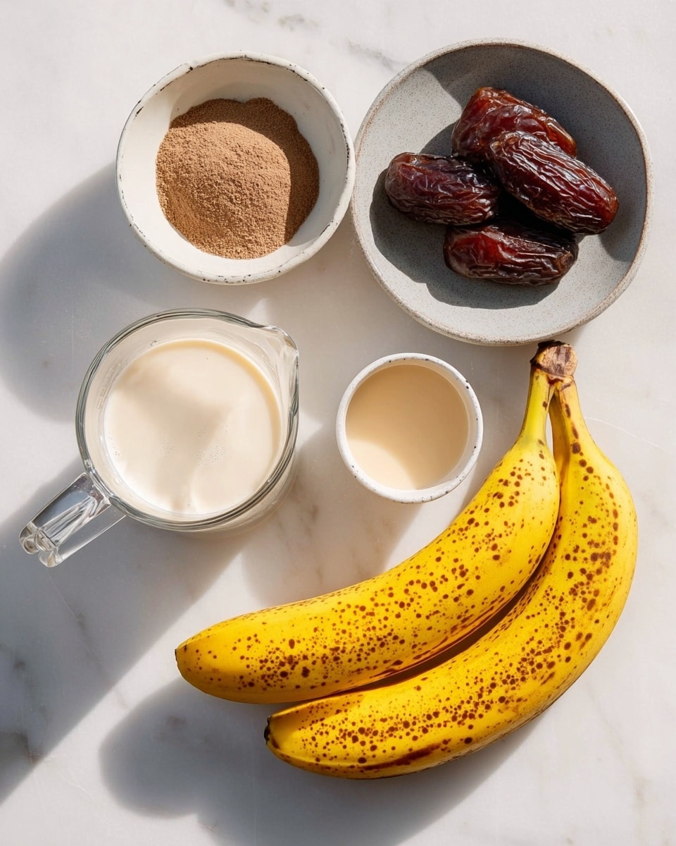 The image shows ingredients laid out on a white marbled surface, including two spotted yellow bananas on the right side close to the bottom, a small white bowl with a light beige creamy liquid near the bananas, a smaller white bowl containing brown powder above the bowl with the liquid, a light gray bowl with four dark brown dates above the smaller bowl, and a clear glass measuring cup filled with white milk on the left side, all arranged neatly with soft natural light casting gentle shadows photo taken with an iphone --ar 4:5 --v 7
