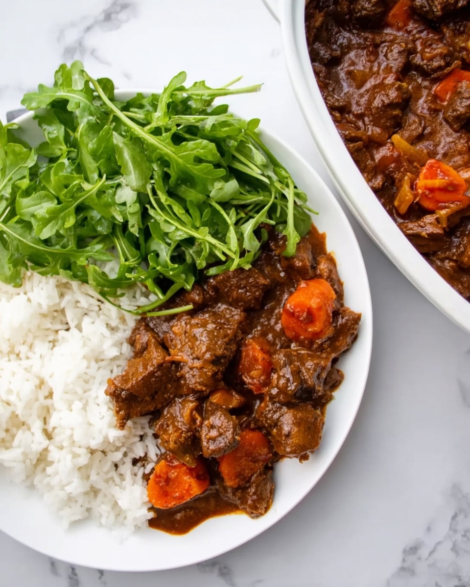A white plate showing three main layers: the bottom layer is white rice, on top of it is a thick dark brown stew with chunks of meat and visible pieces of orange carrot, and on the side is a fresh green leafy salad. Next to the plate is a white dish filled with the same dark brown meat stew, showing chunks of meat and orange carrot in a rich, saucy texture. The background surface is white marble. photo taken with an iphone --ar 4:5 --v 7