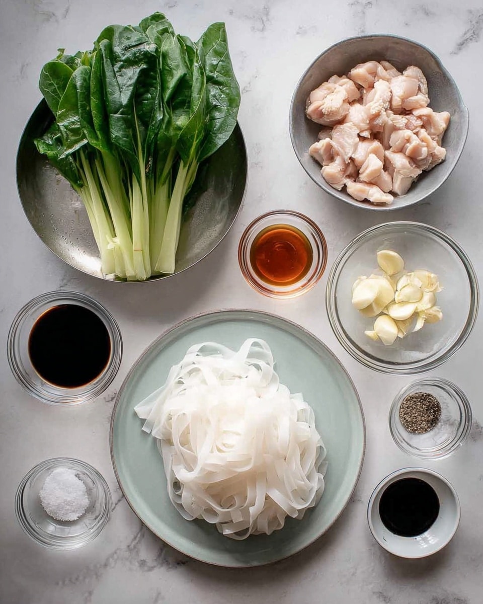 The image shows a clean white marbled surface with various ingredients neatly arranged. In the center, there is a pile of thick, flat white rice noodles on a light gray plate. To the top left, fresh green leafy vegetables stand upright in a silver bowl, while to the top right a silver bowl holds small pieces of raw light pink chicken. Around these main elements are small clear glass bowls containing chopped garlic, dark sauces, light brown sauce, soy sauce, salt, and a small white dish with black pepper. The layout is tidy and well organized, showing all components needed for a cooking recipe, photo taken with an iphone --ar 4:5 --v 7