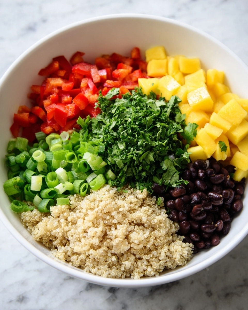A white bowl on a white marbled surface holds six layers of ingredients arranged separately but close. At the front left is a beige layer of cooked quinoa with a soft, grainy texture. To the right of the quinoa is a bright green layer of chopped green onions, sliced thinly into rings. Behind the quinoa on the left is a layer of diced red bell pepper with a slightly shiny, firm texture. Behind this is a fresh green layer of chopped cilantro with leafy, uneven pieces. Next to the cilantro at the back right is a yellow layer of diced mango pieces that are small and cube-shaped. Finally, to the right of the mango is a dark layer of black beans, smooth and round. The layers fill most of the bowl’s surface, showing vibrant colors and fresh textures. Photo taken with an iphone --ar 4:5 --v 7