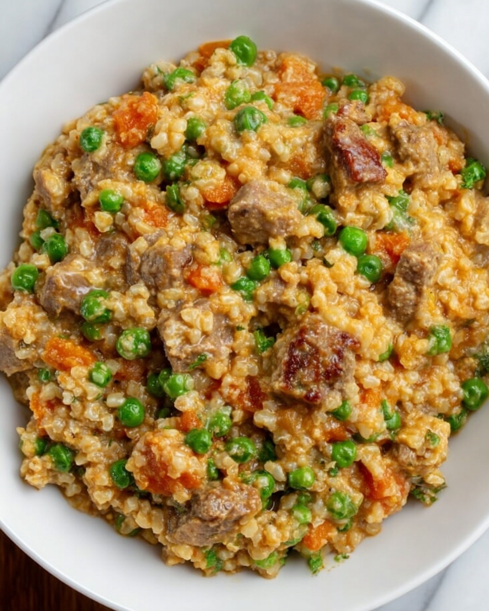 A close-up view of a white bowl filled with a mixed dish made of small pieces of cooked grains that look soft and light brown in color, mixed with bright green peas, chunks of tender brown meat, and orange bits that add color contrast. The dish looks creamy and thick, with all the ingredients evenly spread throughout. The background is a white marbled surface. photo taken with an iphone --ar 4:5 --v 7