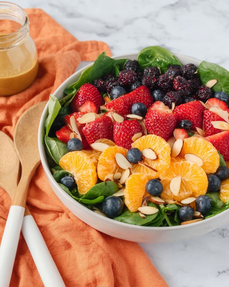 This dish shows a close-up of a black bowl filled with three layers of food. The bottom layer has short spiral pasta with a light orange sauce covering it. Mixed throughout are medium-sized chunks of orange-cooked meat and small pieces of cooked green peppers and purple-red onions. The top layer is garnished with small fresh green herb leaves scattered over the pasta and meat, adding a touch of color contrast. The bowl is placed on a soft pale pink cloth, and the background is a dark blue textured fabric. Photo taken with an iphone --ar 4:5 --v 7