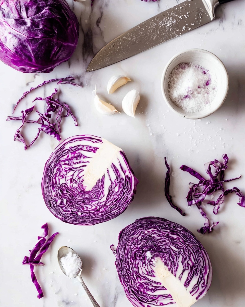 The image shows a white marbled surface with two halves of bright purple cabbage, one positioned near the center and the other near the bottom left corner. Around them are thin, irregular strips of purple cabbage scattered loosely. To the top right lies a small white bowl filled with coarse salt, and nearby are three whole garlic cloves arranged in a slight curve. A large kitchen knife with a silver blade and black handle rests diagonally from the upper middle to top left, with some salt crystals and purple cabbage residue on the blade. A small silver spoon with salt is placed below the knife. The scene has a clean and fresh look with strong color contrast between the purple cabbage and the white marbled texture photo taken with an iphone --ar 4:5 --v 7