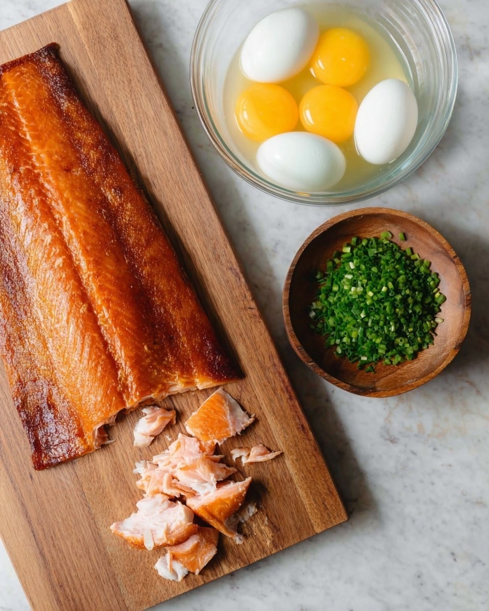 A whole cooked salmon fillet with a golden-brown crispy skin lies on a wooden cutting board, with the right side partly flaked into pink, tender chunks. To the top right, a clear glass bowl holds four raw eggs with bright yellow yolks and some white liquid, showing texture and reflections. Next to the bowl is a small round wooden container filled with finely chopped fresh green chives. The entire scene is set on a white marbled surface. Photo taken with an iphone --ar 4:5 --v 7
