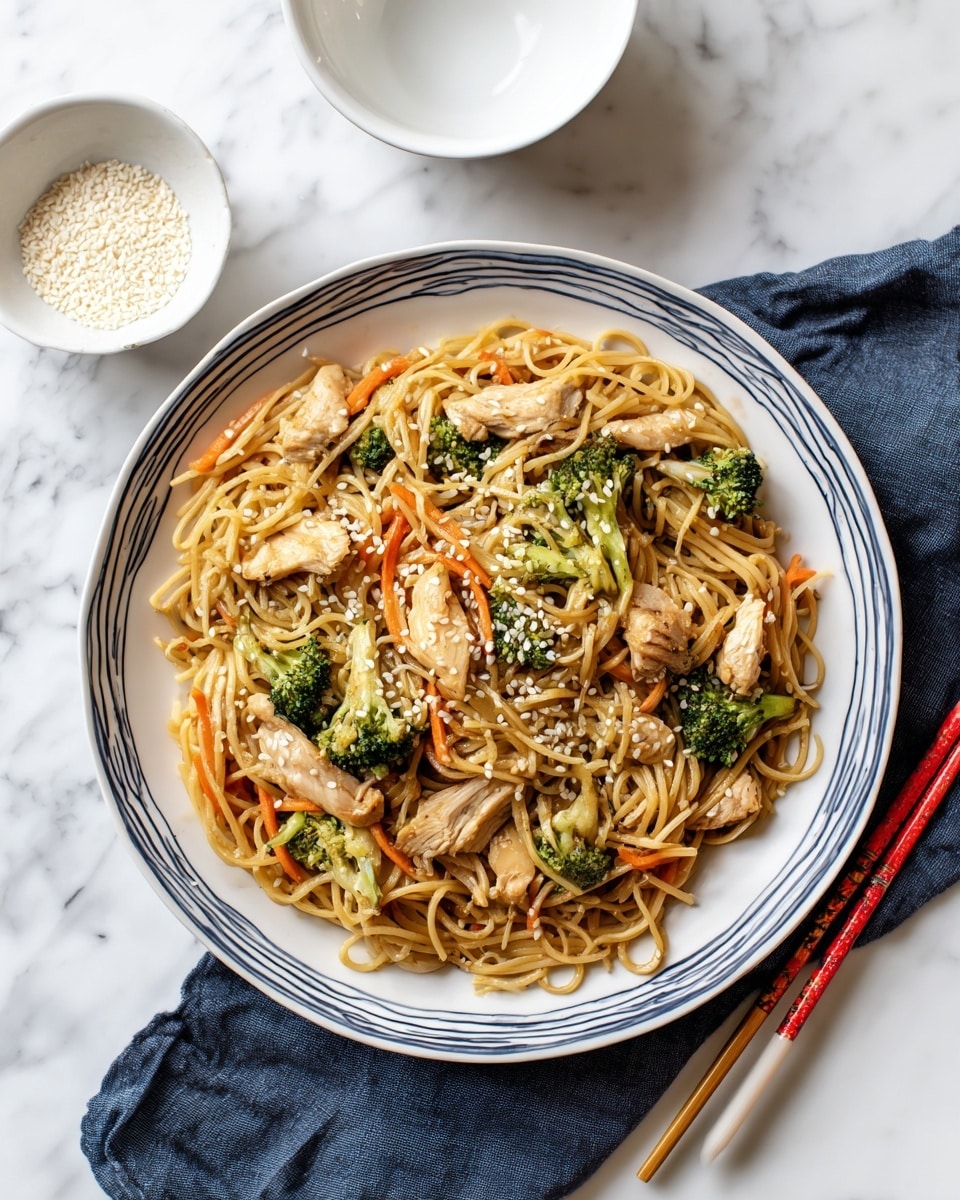 A white round plate with thin blue lines around the edge holds a dish of light brown noodles mixed with small green broccoli pieces and thin light orange carrot strips. On top and mixed in are small light beige slices of cooked chicken. The dish is sprinkled with white sesame seeds. Next to the plate, a white bowl is empty, and a small white dish filled with white sesame seeds sits nearby. Red and gray chopsticks rest on a dark blue cloth on a white marbled surface. Photo taken with an iphone --ar 4:5 --v 7