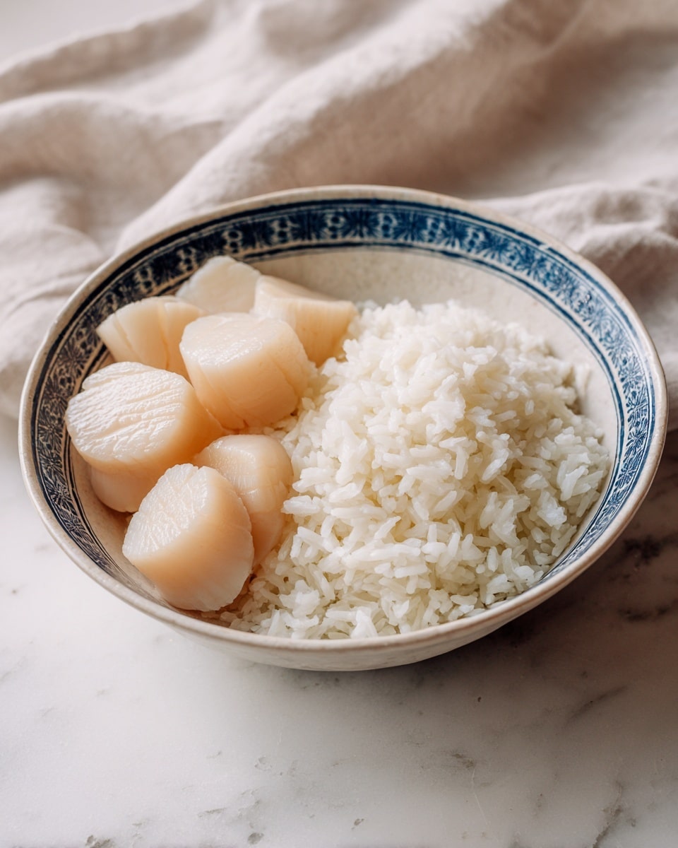 A shallow white bowl with a blue rim holds two main layers: on the left, a neat pile of pale, smooth scallops arranged overlapping each other, showing their soft, glossy texture; on the right, a bed of fluffy, bright white rice with distinct grains visible. The inside of the bowl features a subtle black and grey abstract pattern near the rim. The bowl sits on a white marbled surface with soft, neutral cloths in the background. photo taken with an iphone --ar 4:5 --v 7