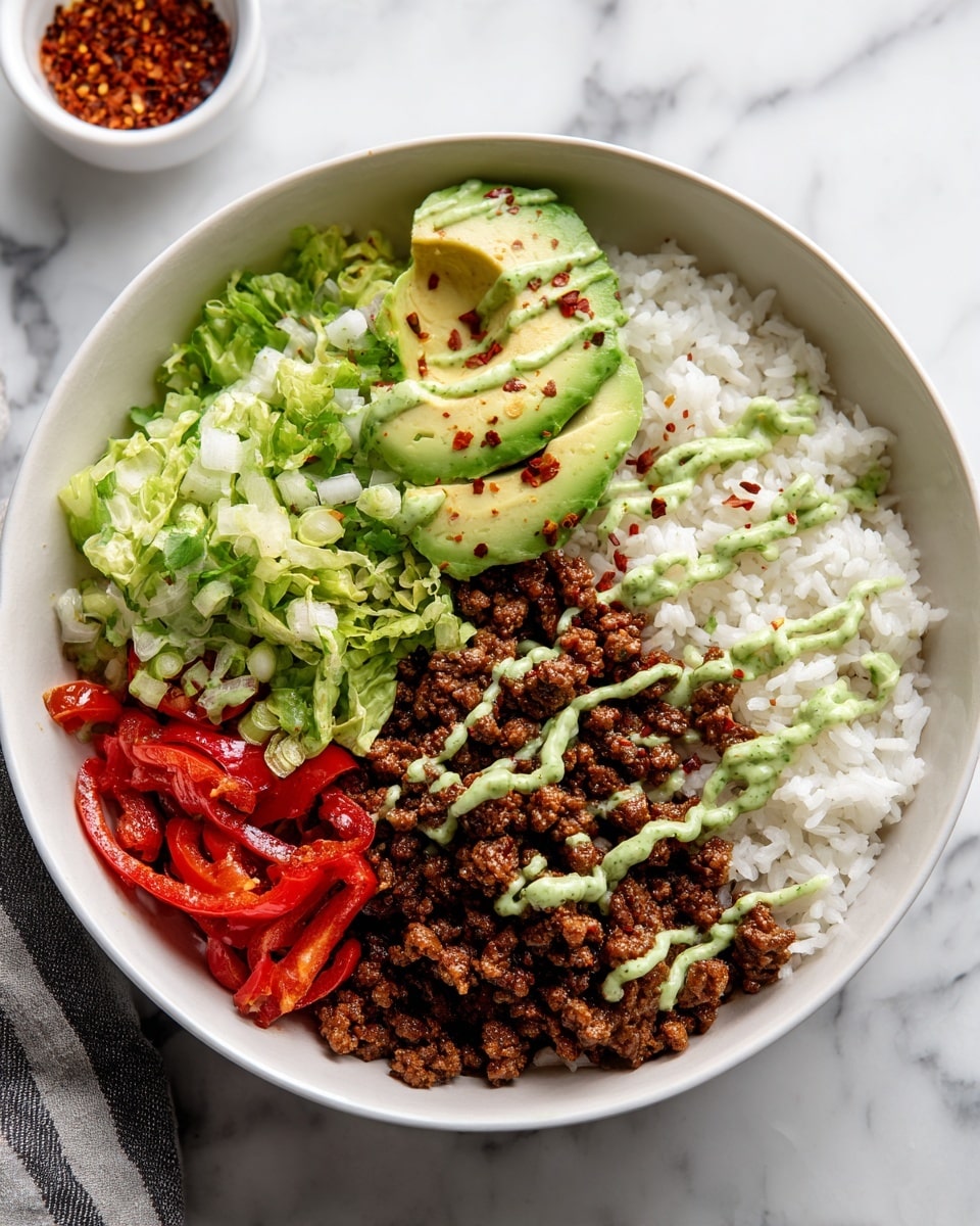 A bowl with four clear layers starting at the bottom with white rice. Above the rice on one side are cooked red peppers and onions with a soft texture. Next to it is a layer of finely crumbled cooked brown textured meat-like mixture. Above that is a layer of chopped light green lettuce and avocado. There are thin green sauce drizzles over the meat and vegetables and small red pepper flakes scattered on top. The bowl is white, placed on a white marbled surface, and a small white bowl with a red spice can be seen in the background. Photo taken with an iphone --ar 4:5 --v 7