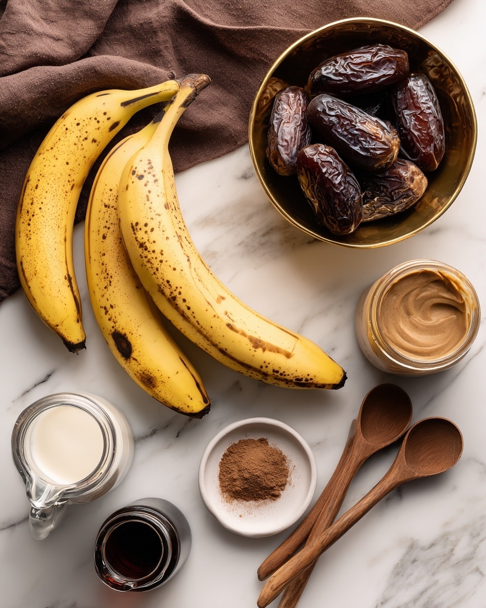 Three ripe yellow bananas with some brown spots lie on a white marbled surface near a dark brown cloth. Below the bananas, three wooden measuring spoons rest in a fan shape. To the right, a gold and brown bowl filled with dark, wrinkled dates sits next to a glass carafe filled with dark liquid and an open jar of creamy light brown spread. At the bottom left, a clear glass pitcher with white liquid is partly visible. In the lower foreground, a small glass bottle with dark liquid is present, along with a white dish holding a brown powder. All items are placed on the white marbled surface. Photo taken with an iphone --ar 4:5 --v 7