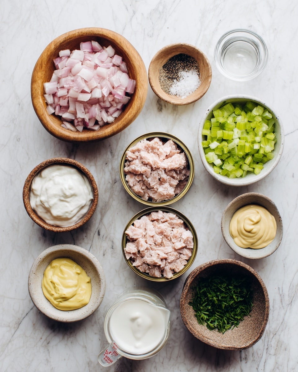 The image shows eleven small bowls and two open cans of light pink tuna on a white marbled surface. From top left, there is a wooden bowl filled with small pink onion pieces, a small wooden bowl with white salt and black pepper mixed, and a white bowl with a light clear liquid, all lined in a row. Below these, the two open tuna cans sit side by side, with light pink tuna inside. To the right of the lower can, there is a measuring cup with thick white yogurt, and next to it a white bowl with green chopped celery. Between the onions and tuna cans is a beige bowl with smooth white mayonnaise, and below it, a small white dish with yellow mustard. To the right of that, a rustic brown bowl holds chopped green herbs. The bowls and cans are neatly arranged, and the whole scene is brightly lit. Photo taken with an iphone --ar 4:5 --v 7