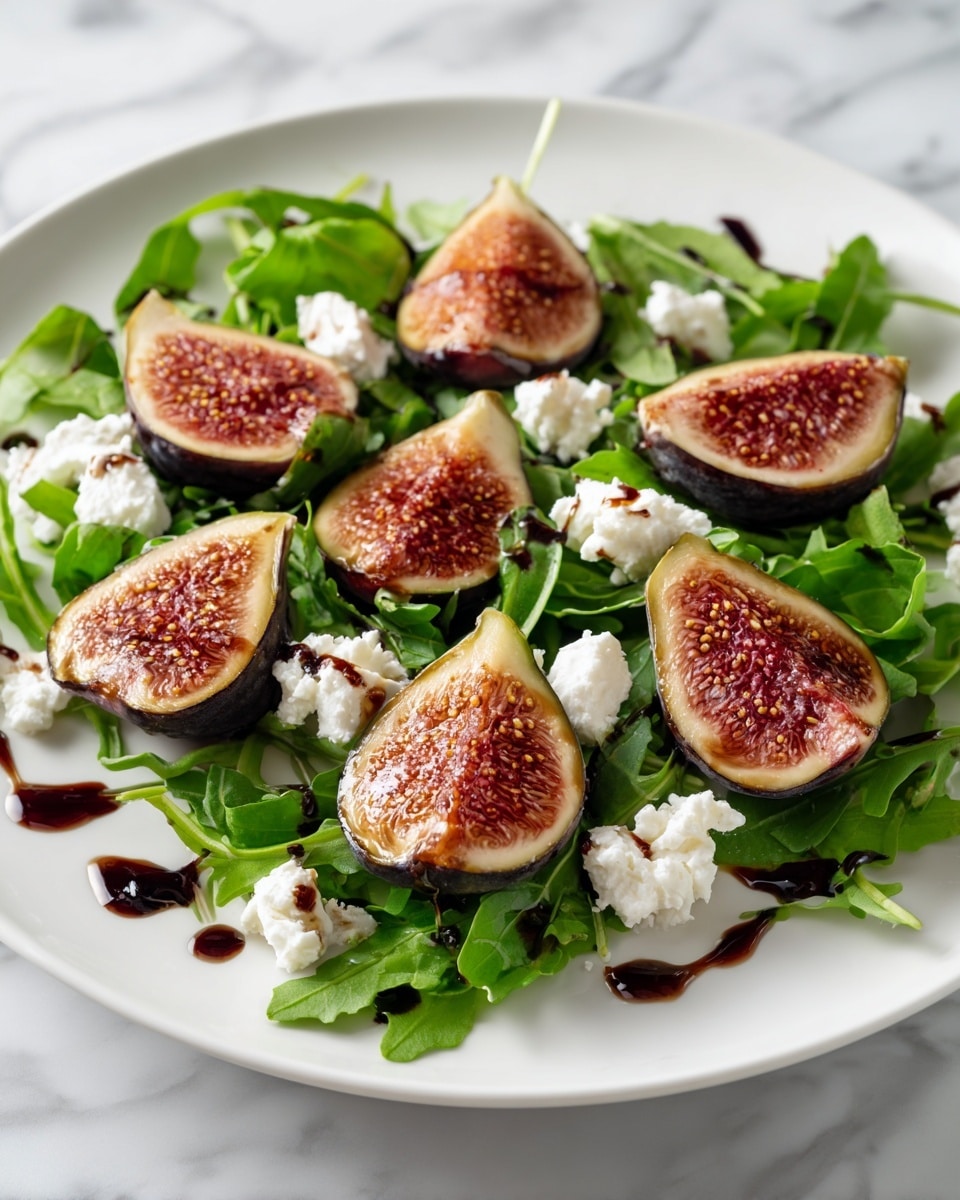A white plate holds a fresh salad arranged in three visible layers: the bottom layer is a bed of bright green arugula leaves with a slightly curly and soft texture, spaced evenly across the plate. On top, there are six fig halves placed in a loose circle, each showing their deep reddish-pink inner flesh with tiny seeds and a smooth outer skin that is dark purple with light edges. Dollops of white, fluffy cheese are scattered between the figs, adding a soft and creamy texture. The salad is finished with thin streams and small drops of dark brown balsamic glaze drizzled artistically over the figs, cheese, and arugula, and the surface beneath the plate is a white marbled texture. photo taken with an iphone --ar 4:5 --v 7