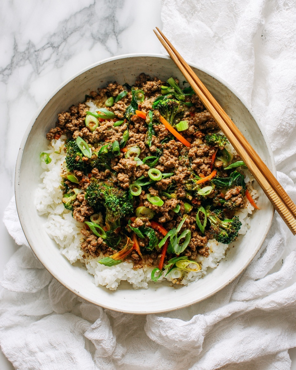 A white bowl filled with three layers is shown on a white marbled surface with a white cloth nearby. The bottom layer is white cooked rice with a soft texture. On top of the rice is a layer of cooked ground meat in small, uneven pieces colored light brown. Mixed with the meat are thin orange carrot sticks and small, green broccoli florets adding fresh color. Thinly sliced green onions are scattered on the top layer for garnish. A pair of light-colored wooden chopsticks rest horizontally on the bowl's rim. Photo taken with an iphone --ar 4:5 --v 7