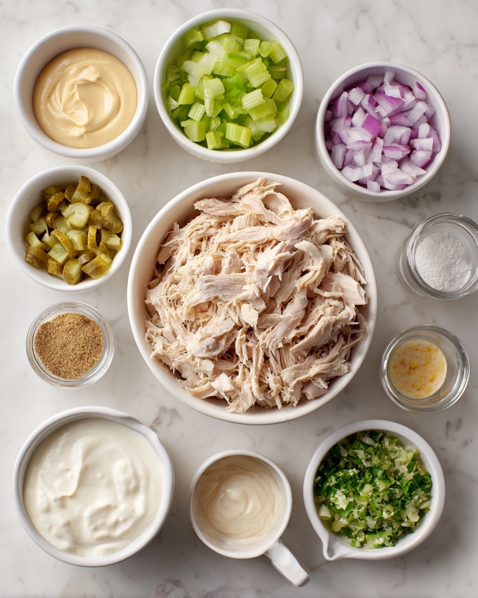 A white bowl in the center is filled with shredded light beige chicken. Surrounding it are small white bowls and measuring cups with different ingredients: one with chopped light green pickles, one with small chopped pale green celery, one with a thick off-white sauce, one with pale yellow mustard, one with chopped green herbs, one with finely chopped light purple onions, one with creamy white mayo, one measuring cup with thick white sour cream, one small bowl with light tan powdered spice, and one small bowl with white liquid and a few tiny yellow seeds. The setup is on a white marbled surface. Photo taken with an iphone --ar 4:5 --v 7